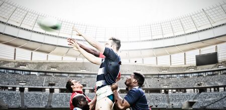 Rugby Players Playing Match against rugby goal post on a sunny day in the stadiumの写真素材