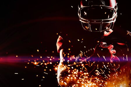 American Football Player against firework bursting sparkle backgroundの写真素材