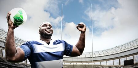 Strong Rugby Player against rugby goal post on a sunny day in the stadiumの写真素材