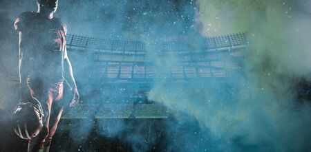 American Football Player against splashing of yellow color powderの写真素材