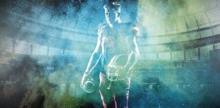 American Football Player against splashing of yellow color powderの写真素材