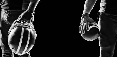 American football player standing with rugby ball, Close-upの写真素材