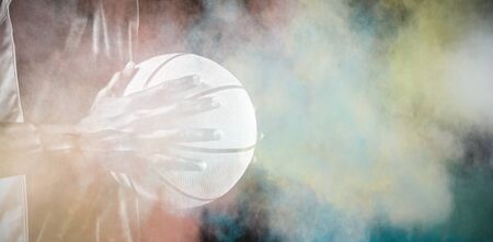 Basketball player against splashing of color powderの写真素材