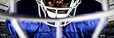 American Football Player against rugby goal post on a sunny day in the stadiumの写真素材