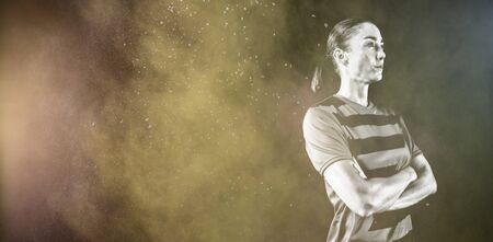 Tough female soccer player against splashing of color powderの写真素材