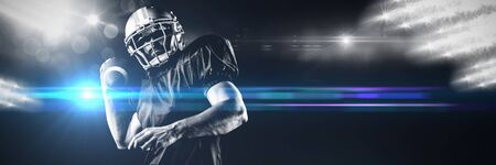 American Football Player against view of spotlightsの写真素材