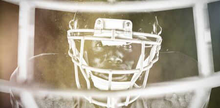 American Football Player against splashing of color powderの写真素材