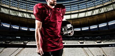 American Football Player against rugby goal post on a sunny day in the stadiumの写真素材