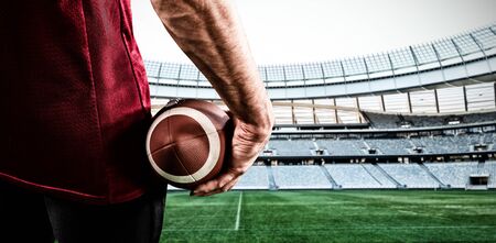 American Football Player against rugby stadium at dawnの写真素材