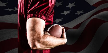 American Football Player against focus on usa flagの写真素材