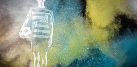 Tough female soccer player against splashing of color powderの写真素材