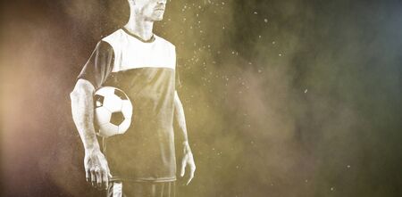 Focused Soccer Player against splashing of color powderの写真素材