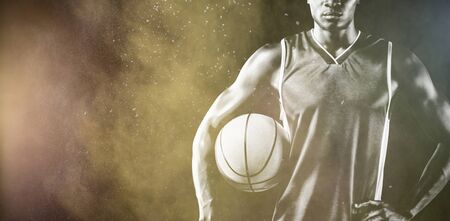 Basketball player against splashing of color powderの写真素材