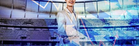 Businesswoman holding tablet pc against stocks and sharesの写真素材