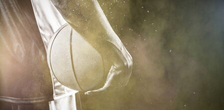 Basketball player against splashing of color powder