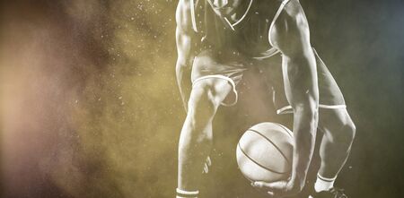 Basketball player against splashing of color powderの写真素材