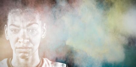 Tough female soccer player against splashing of color powder