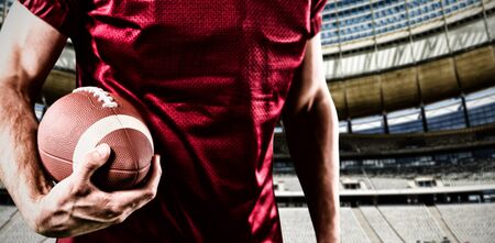American Football Player against rugby goal post on a sunny day in the stadiumの写真素材