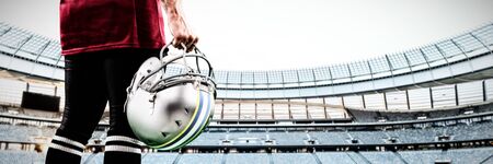 American Football Player against rugby stadium at dawnの写真素材