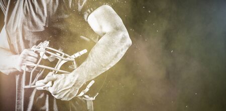 American Football Player against splashing of color powder