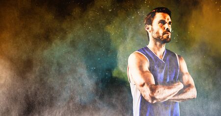 Basketball player against splashing of yellow color powderの写真素材