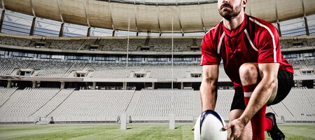 Tough Rugby Player against rugby goal post on a sunny day in the stadiumの写真素材
