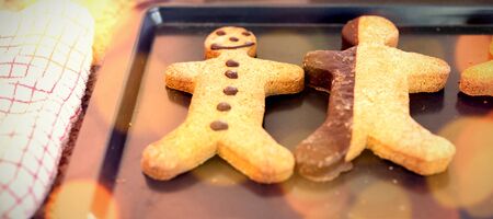 Composite image of brown parquet against christmas cookies in kitchen at homeの写真素材