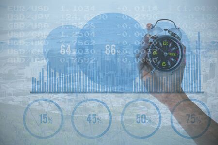 Cropped hand of man holding alarm clock against view of crowded cityscape Aerial view of crowded cityscapeの写真素材