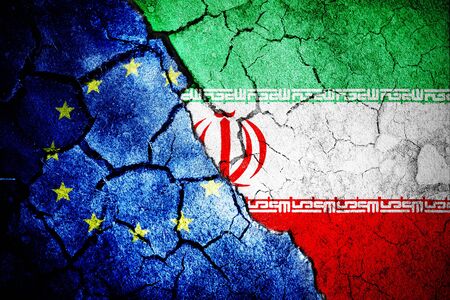 Digitally generated iran national flag against close-up of european flagの写真素材