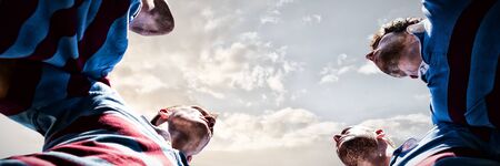 Rugby players against cloudy sky landscape