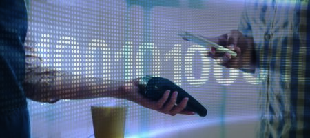 Binary code on digital screen against man making payment through nfc technology in cafe
