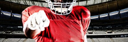 American football player against rugby goal post on a sunny day in the stadiumの写真素材