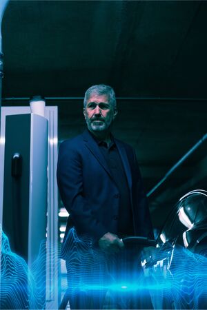 Blue wave against businessman charging electric car at charging station
