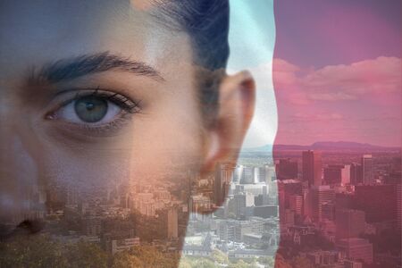 Cropped portrait of young woman against view of city skyline