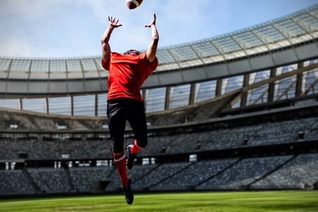 American Football Player against rugby stadium on a sunny day