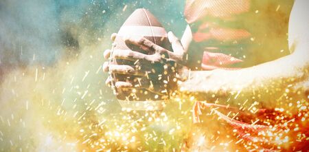 American Football Player against splashing of powderの写真素材