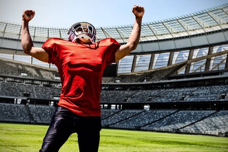 American Football Player against rugby goal post on a sunny day in the stadium