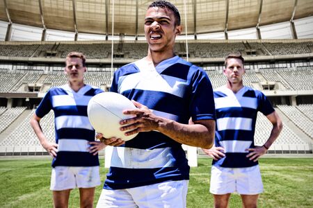 Rugby Player against rugby goal post in a stadiumの写真素材