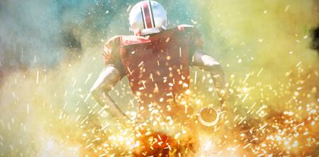 American Football Player against splashing of powderの写真素材