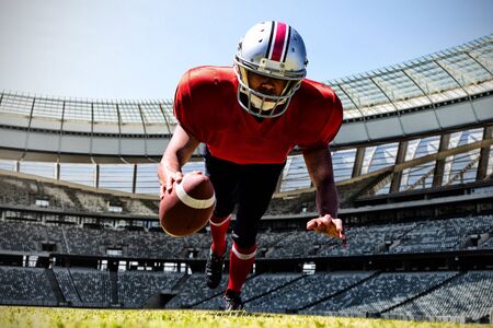 American Football Player against rugby goal post on a sunny day in the stadium
