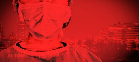 Portrait of surgeon woman against metropolitan city with waterfront. Testing for Coronavirus, global pandemic conceptの写真素材