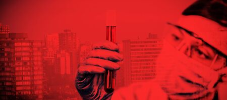 Female scientist conducting an experiment against buildings against sky during sunset. Testing for Coronavirus, global pandemic conceptの写真素材