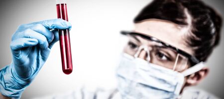 Female scientist conducting an experiment against white background. Testing for Coronavirus, global...