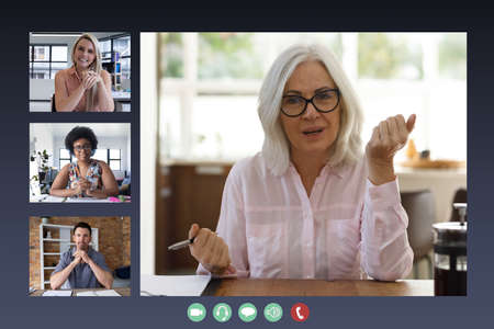 Diverse businesswomen and businessman displayed on computer screen during video call. social...