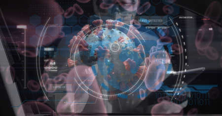 Digital illustration of macro Covid-19 cell with data, statistics and numbers floating over scientist wearing protective clothes, using tablet. Coronavirus Covid-19 pandemic concept digital compositeの写真素材