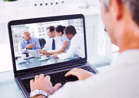 Couple during a video call with their friends and family on computer self isolating at home with coronavirus Covid 19 spreading. Public health social distancing and self isolation in quarantine lockdown concept digital composite.の写真素材