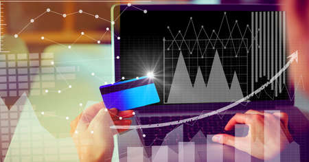 Financial data processing over woman holding credit card and using laptop. global business and...