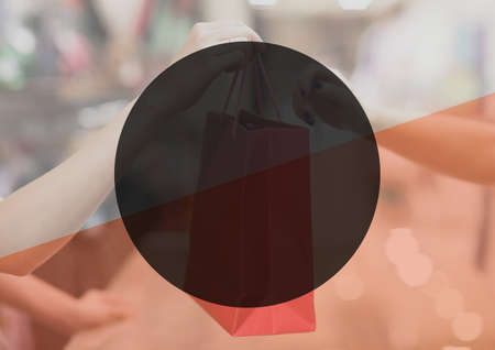Shopping bag given to female customer by female shop assistant and circle with copy space. retail and shopping concept digitally generated image.の写真素材