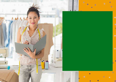 Portrait of smiling asian female fashion designer at work with yellow and green copy space on right....