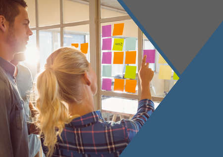 Composition of business colleagues brainstorming in office with grey and blue triangular copy space....